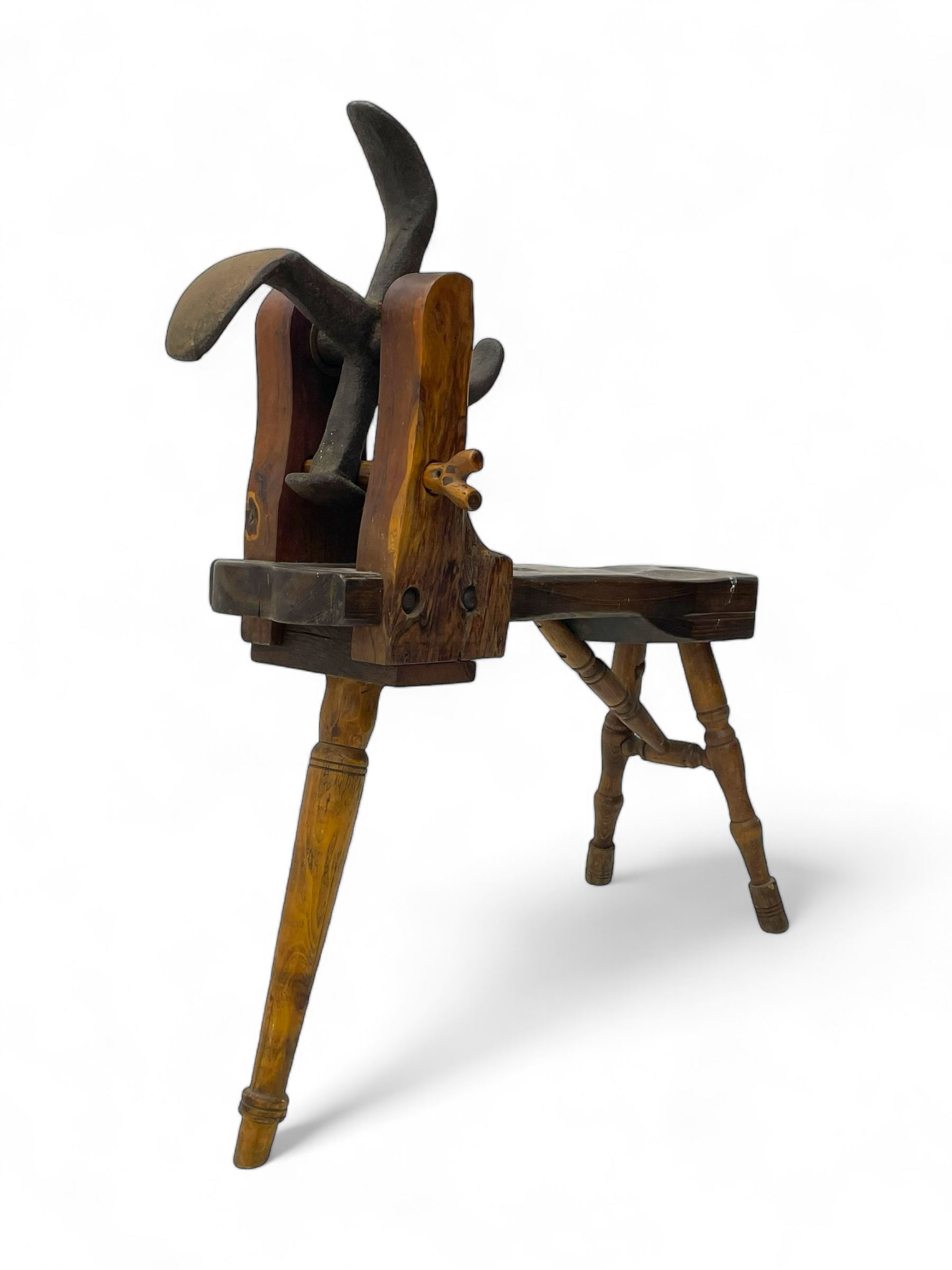 Early 19th century cobbler's work bench, in various woods, revolving cast iron last on yew wood supports, pine seat with inset maker's plaque inscribed 'No 7 Josh Blacker Harehills Leeds', on turned elm front supports and turned beech rear supports 