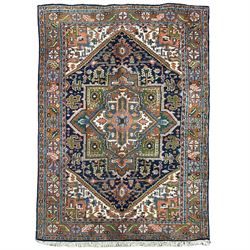 Persian Heriz indigo and rust ground rug, central geometric star medallion decorated with ...