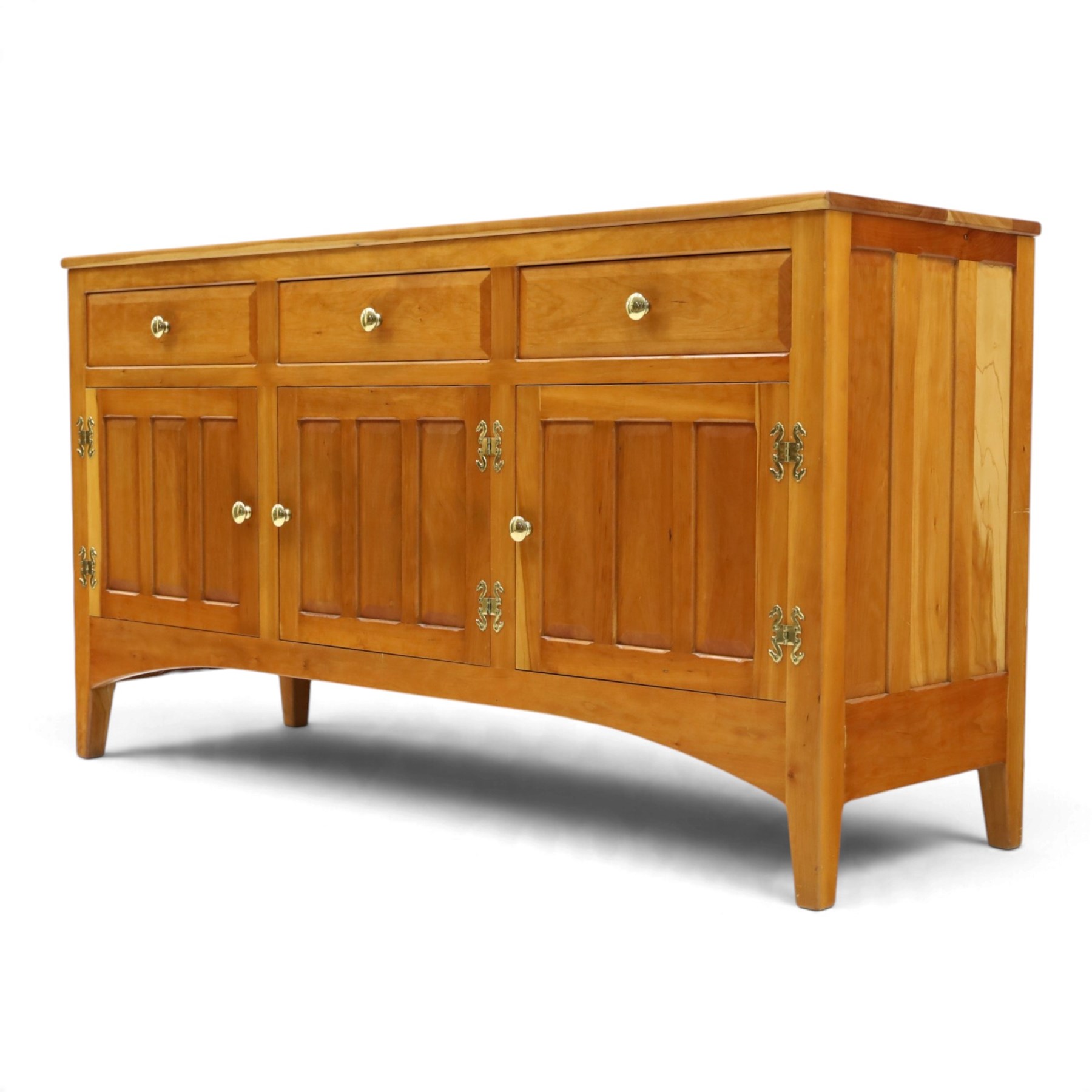 Traditional cherrywood sideboard, rectangular top above three fielded panelled drawers, three cupboard doors with triple panelled doors, brass knobs and hinges, tapered supports