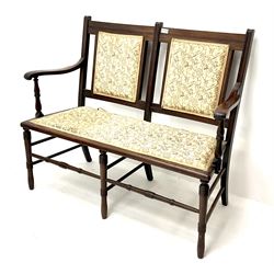 Late Victorian mahogany framed two seat settee, upholstered seat and back in floral fabric, turned supports joined by stretcher 