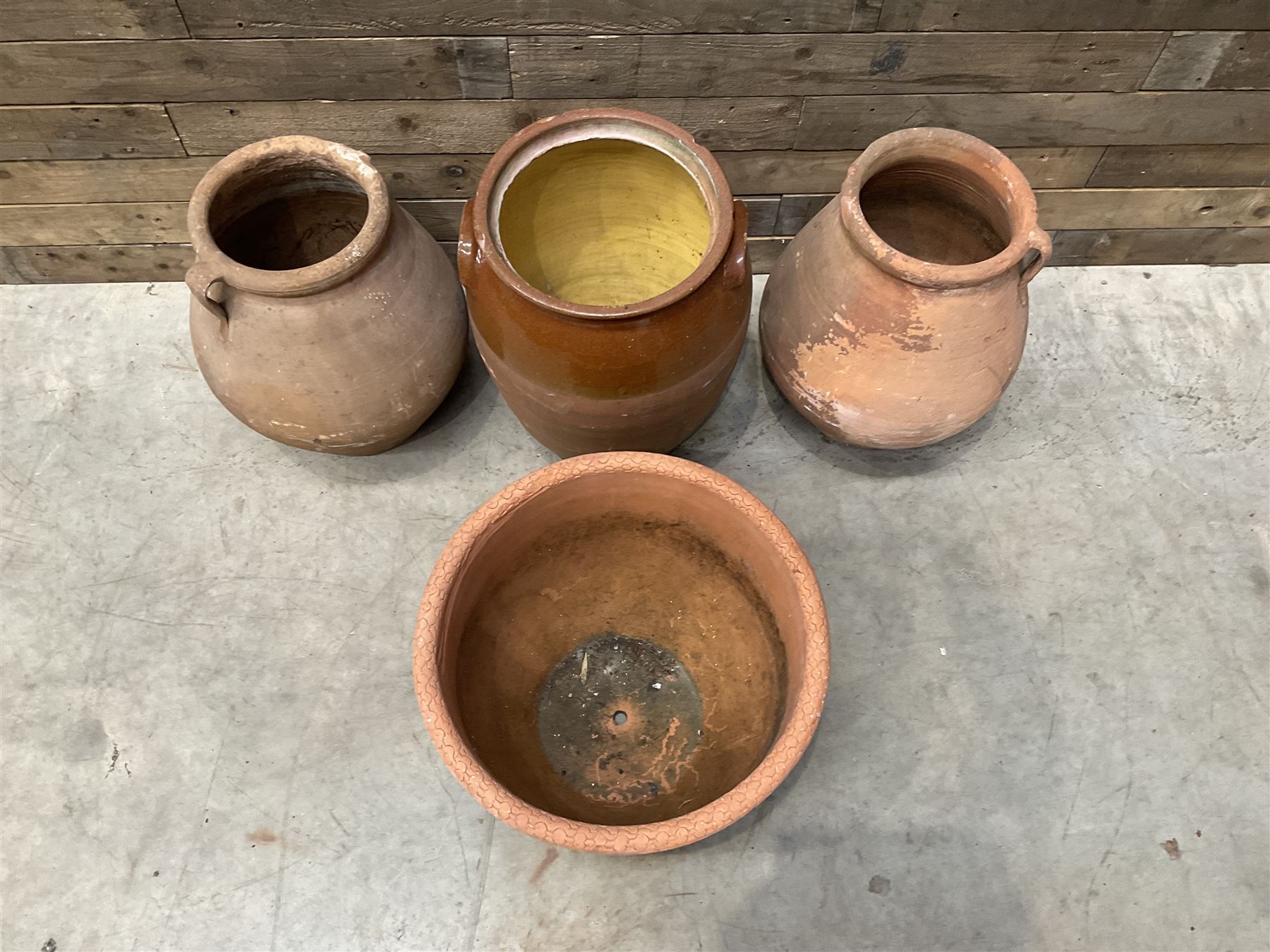 Pair of terracotta water jugs, H46cm, glazed pancheon and a circular planter (4)