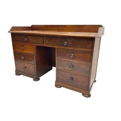 19th century mahogany knee hole desk, rectangular top with raised back, eight drawers with turned handles, skirted base on compressed bun feet