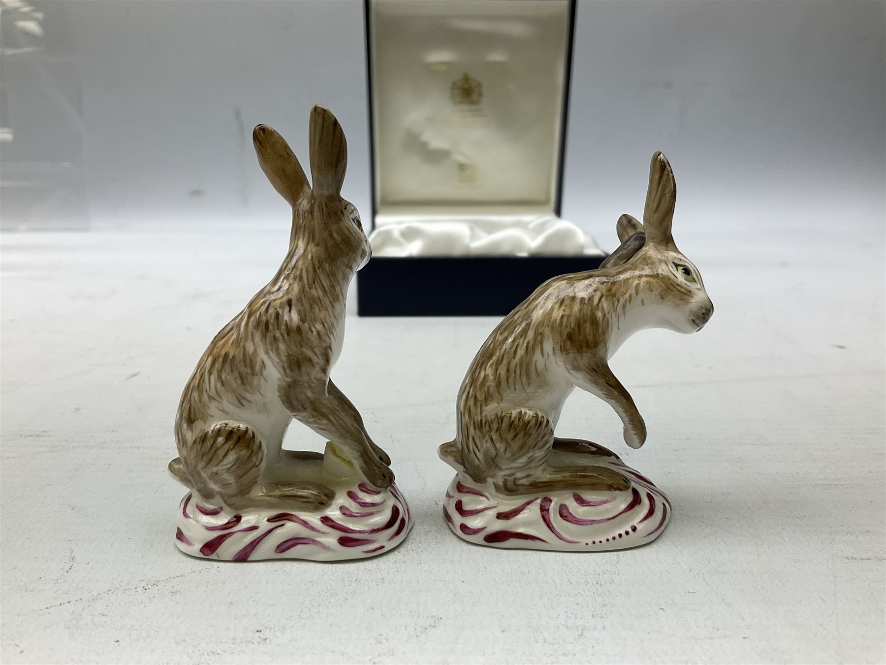 Two Halcyon Days porcelain figures of hares, inspired by Bow porcelain hare c1755, in box 