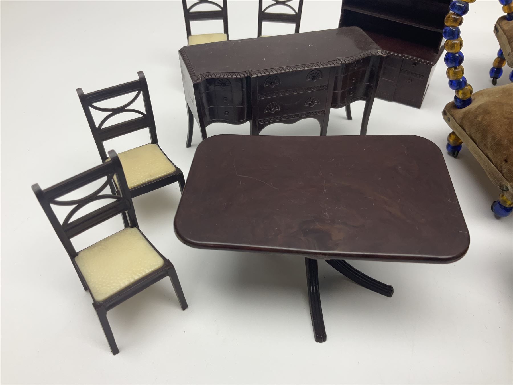 Quantity of early 20th century doll's house furniture comprising Victorian style beadwork and upholstered eight-piece salon suite; beadwork dining table with four matching chairs; and Kleeware brown plastic seven-piece dining suite