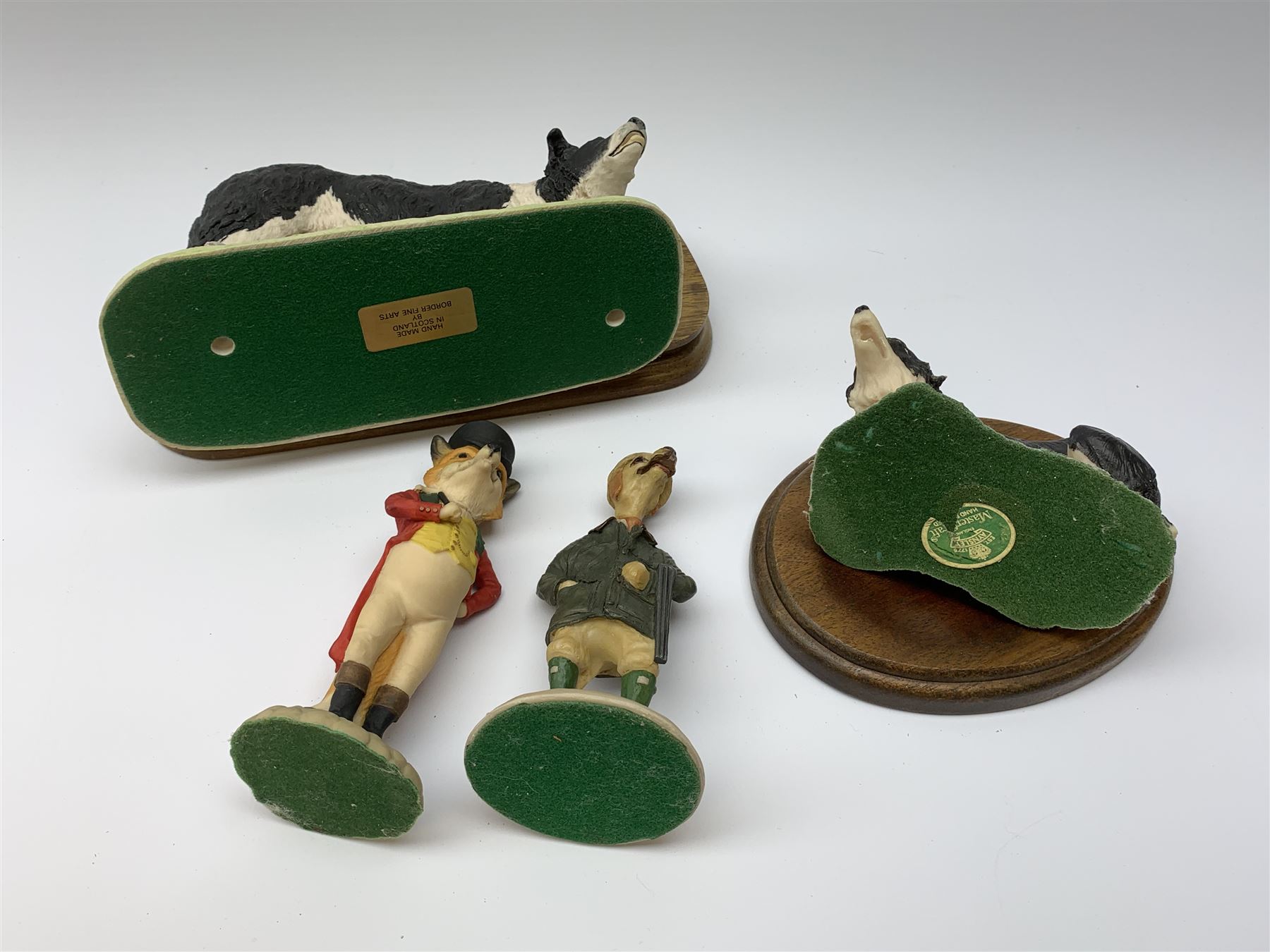 A Border Fine Arts model of a Border Collie, by Elizabeth Waugh, a Sherratt and Simpson model of a Border Collie, and an Aynsley Master Craft model of a Border Collie, plus two further figures, one modelled as a fox is riding jacket, the other as a dog with shotgun. 