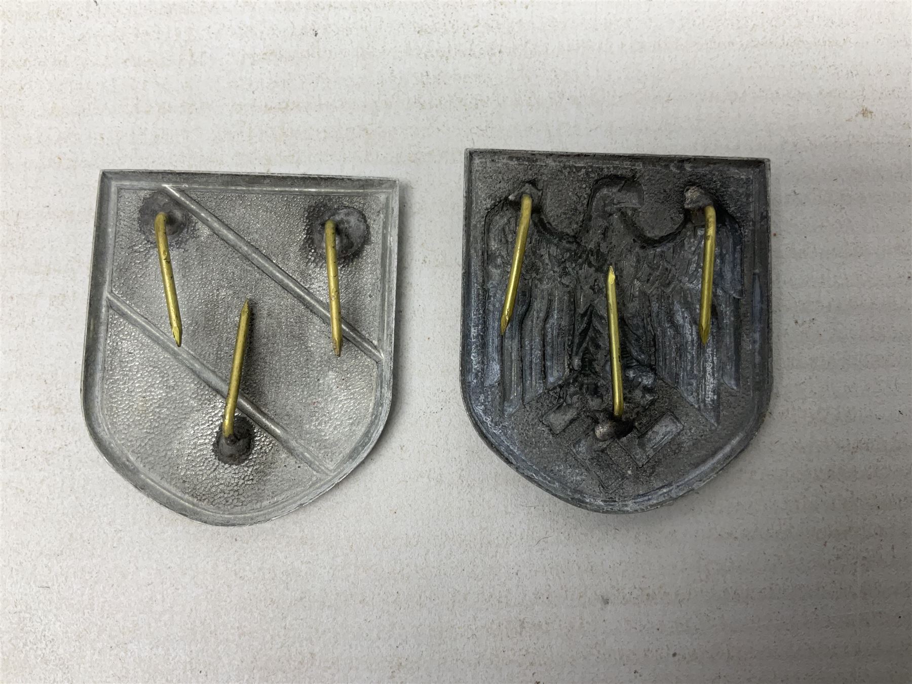 Two WW2 German 'tinnie' badges - Labour Day 1935 by Overhoff & Cie Ludenscheid & Labour Day 1936 by Ziemer & Sohne Oberstein/Nahe; together with pair of Afrika Korps tropical (pith) helmet metal decals (4)