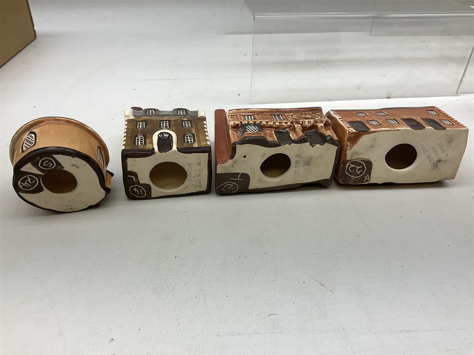 Twenty studio pottery figures of houses and cottages, comprising seventeen Mudlen End Studio Felsham Suffolk examples and two John Putman's Heritage Houses examples