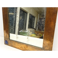  Arts & Crafts rectangular wall mirror with planished copper frame, inset with four blue and turquoise Ruskin cabochons and riveted borders, probably retailed by Liberty of London 63.5cm x 53cm  