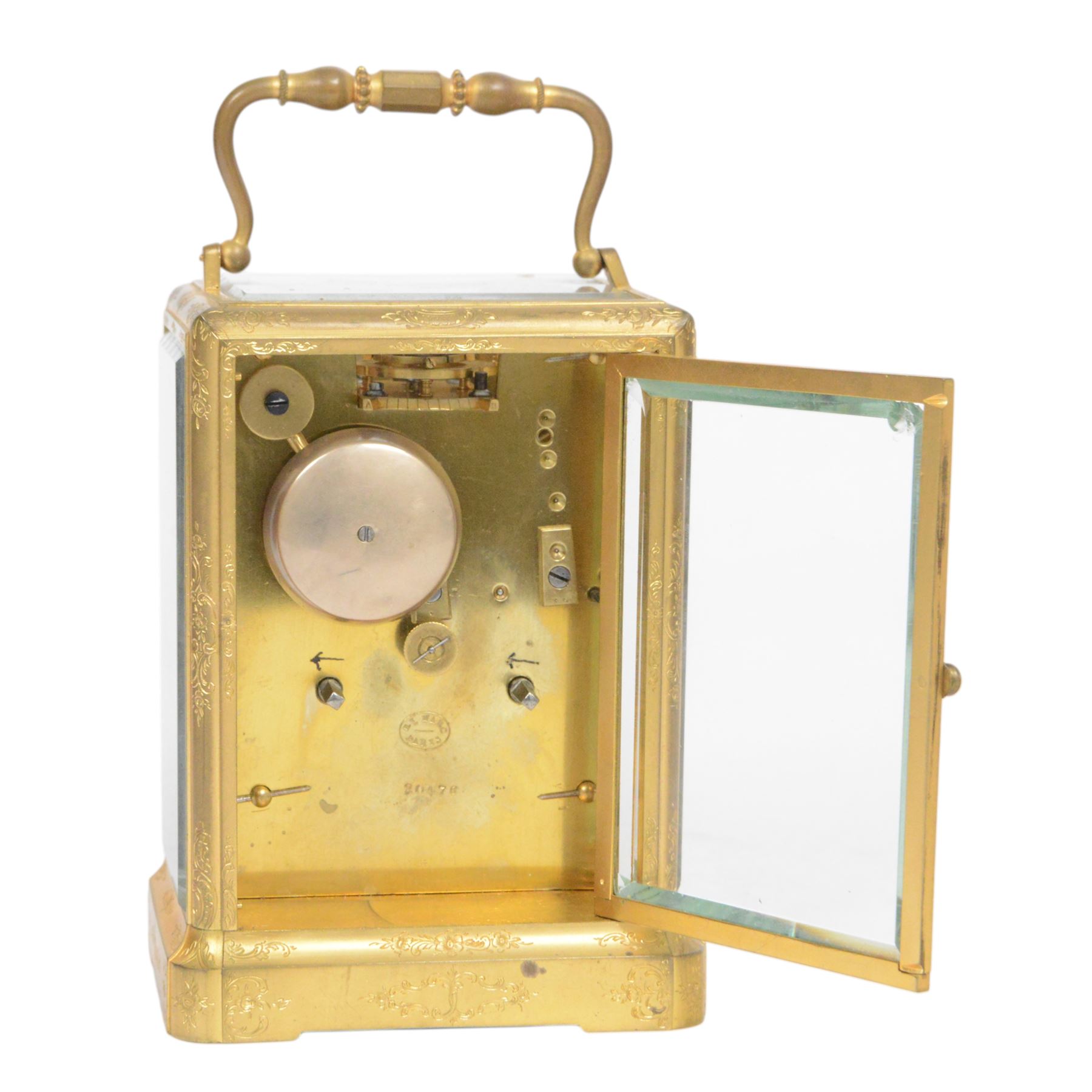 Late 19th century French 8-day brass cased carriage clock, Henry Marc of Paris, the gorge case with swing handle and four bevelled glass panels, white enamelled dial with Roman numerals and minute markers and steel hands, the two train movement with platform lever escapement, hour striking on a bell, with key