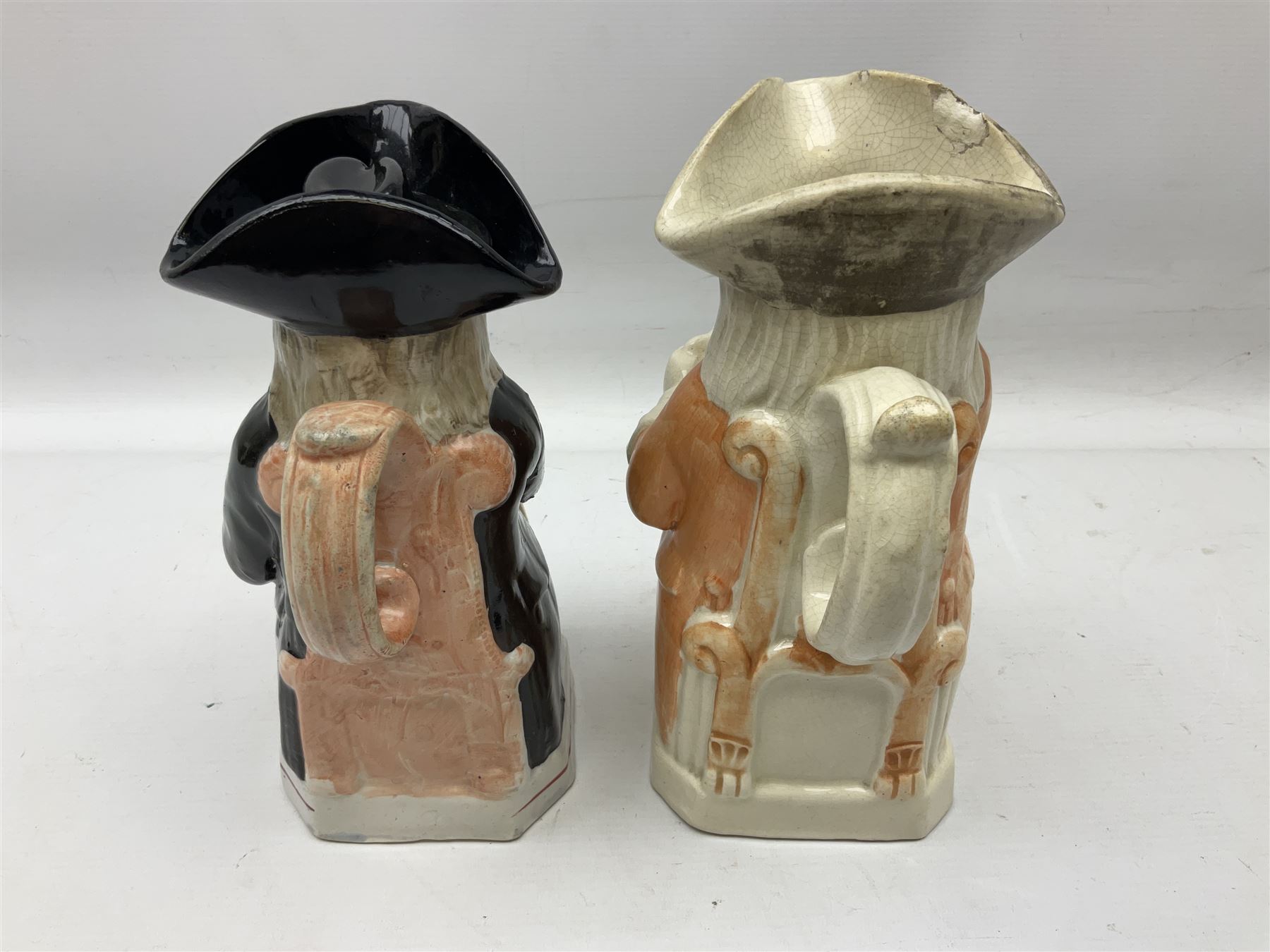 19th century and later Toby jugs comprising Staffordshire Punch and Judy jugs, Victorian 'I am on the black list' jug, two jugs in the form of Toby with a jug of beer (5)