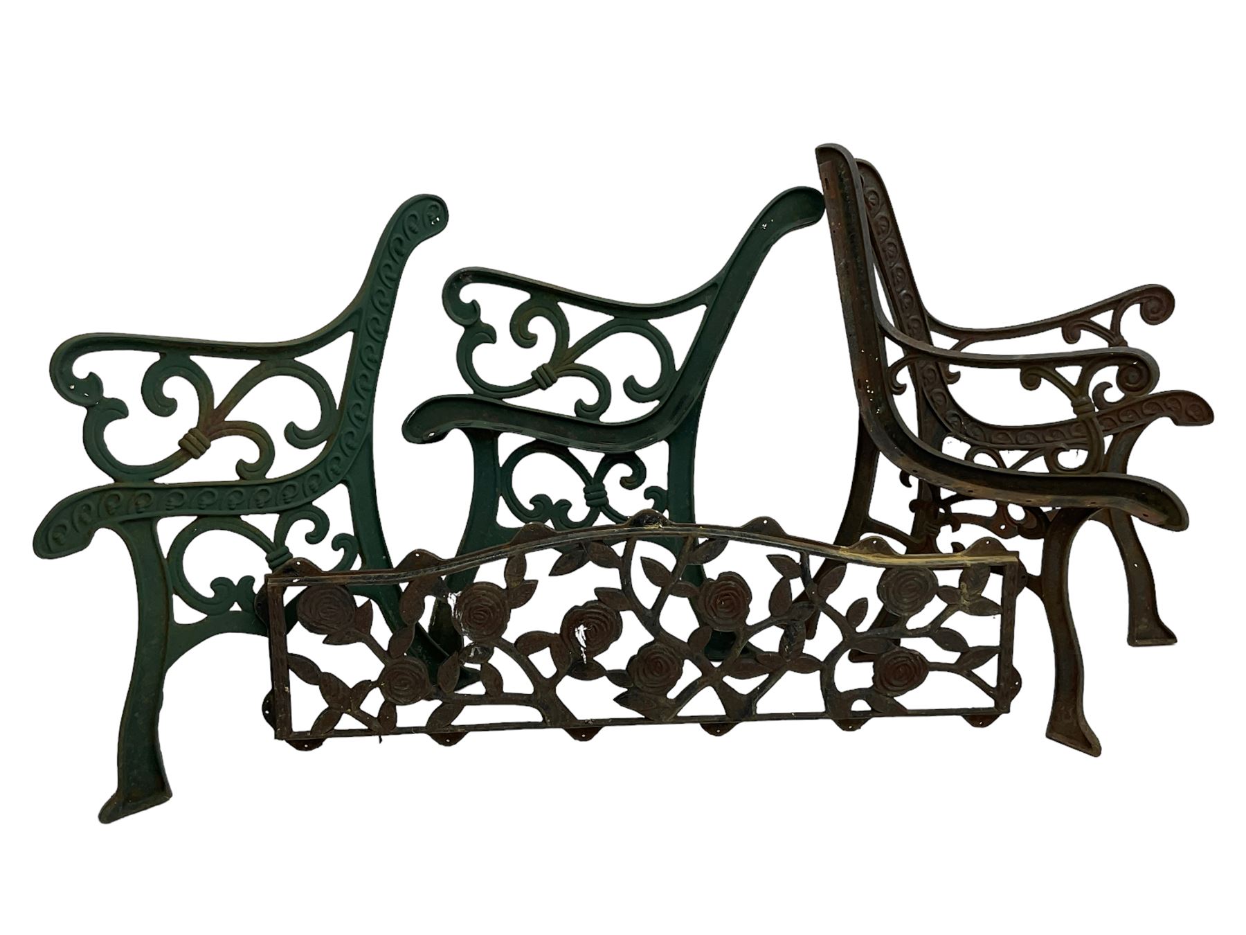 Pair cast iron garden bench ends decorated with scrolling design (H83cm), another pair of cast iron bench ends (H78cm), and a cast iron bench back decorated with foliage branches and roses (W110cm x H30cm)