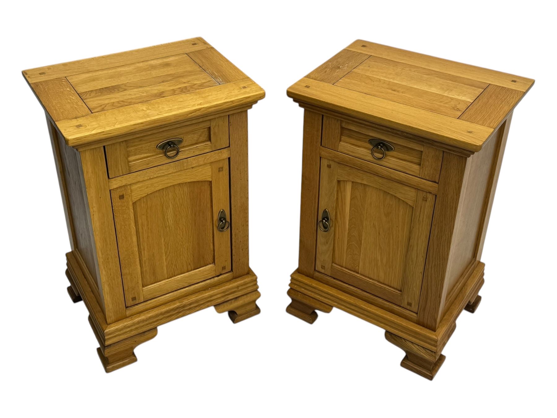 Frank Hudson - contemporary pair of light oak bedside cabinets, each with moulded rectangular top over single drawer above cupboard door with arched panel, on a moulded plinth base with bracket feet