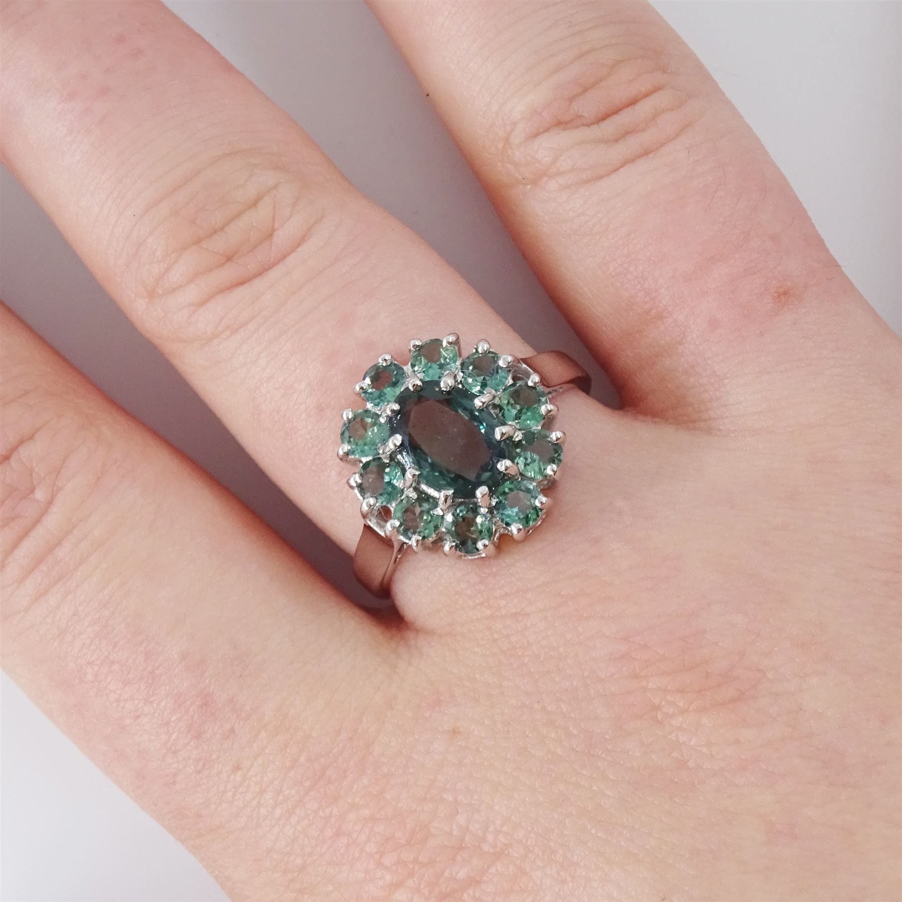 18ct white gold green sapphire cluster ring, oval cut sapphire of approx 1.40 carat, surrounded by ten round cut sapphires, Birmingham 2005, total sapphire weight approx 2.40 carat