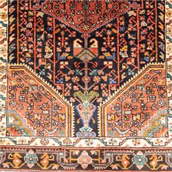 North West Persian Koliahee hand-knotted runner, indigo field with three large linked lozenge medallions in a madder red, framed by angular floral motifs and stylized vines within ivory and terracotta geometric borders, fringe ends  