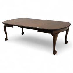 Early 20th century dining table, moulded oval top with gadroon carved edge, fitted with two additional leaves, raised on cabriole legs with shell carved knees and claw and ball feet