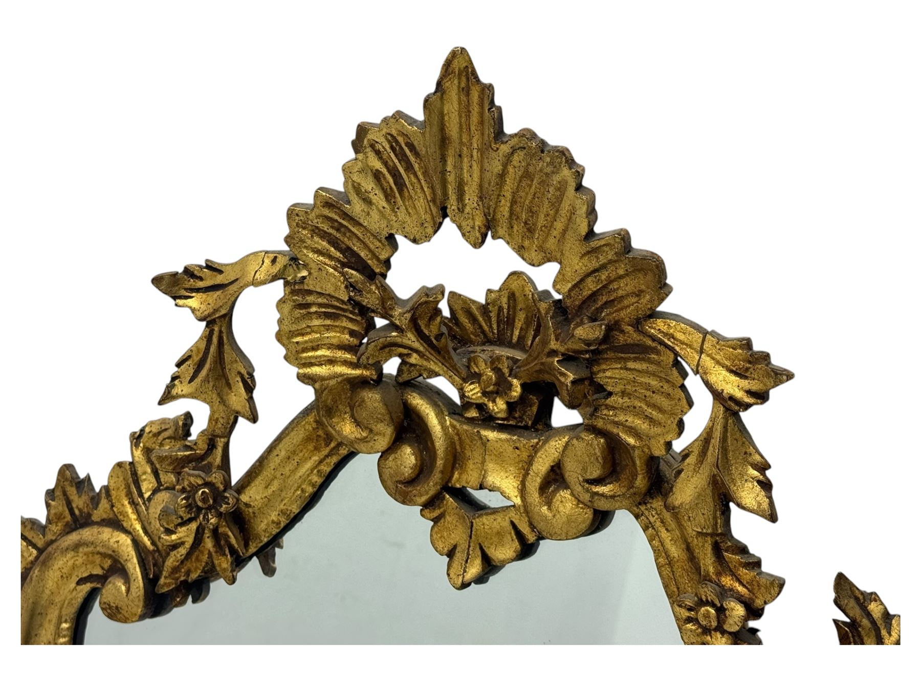 18th century design gilt framed wall mirror, within a pierced and scrolling foliate frame, leaf sprays and flowerhead cresting