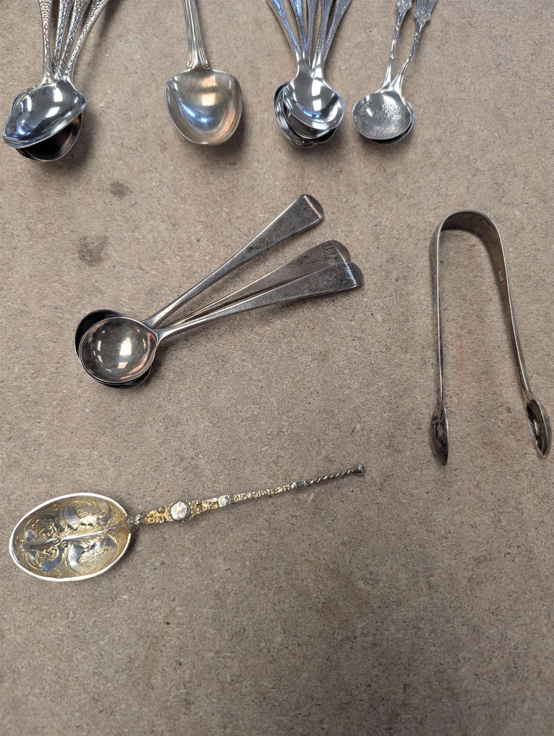 Collection of silver teaspoons, including souvenir and American silver examples, together with a silver handled fork and a mother of pearl handled silver knife, all stamped or hallmarked 