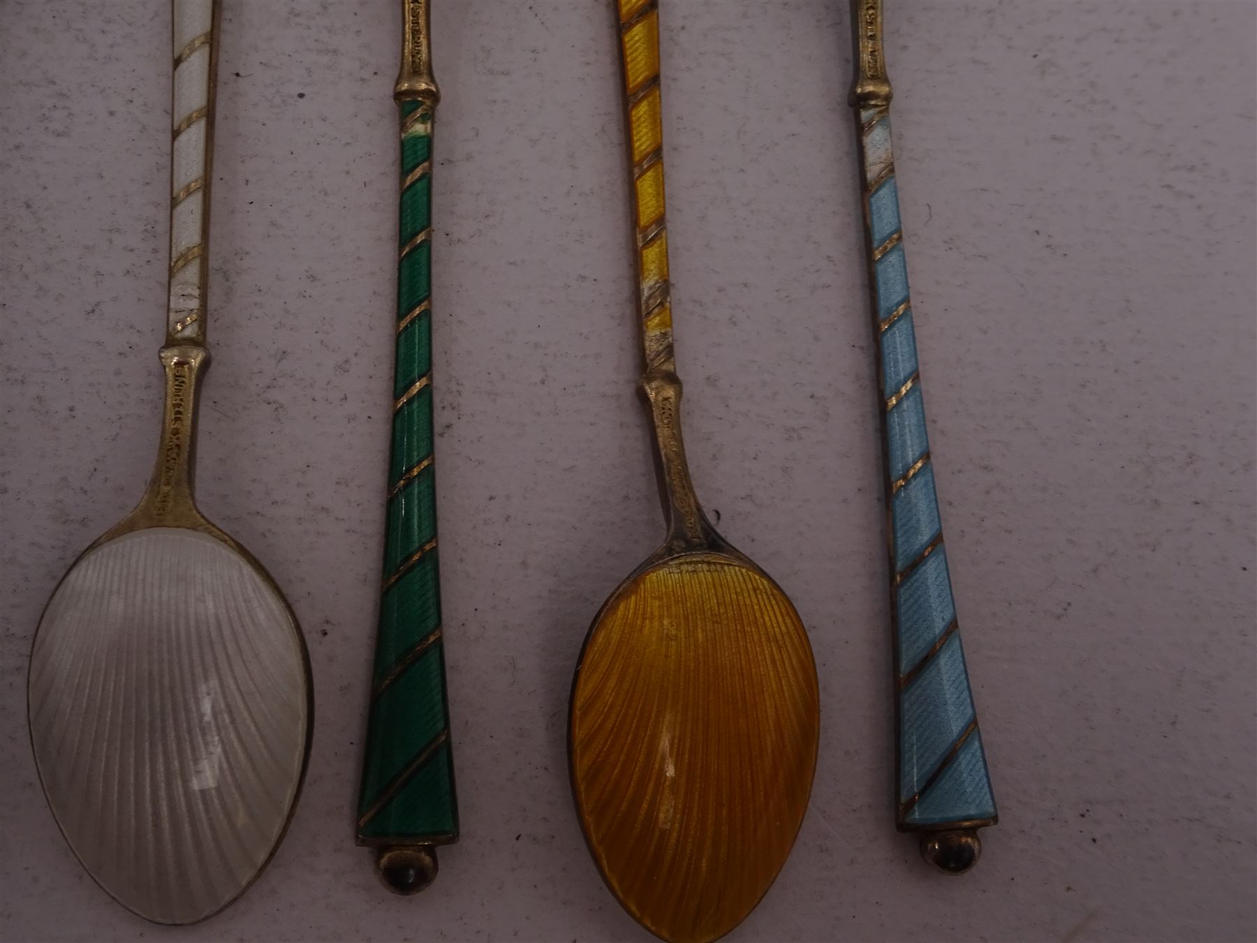 Set of six Danish silver gilt coloured guilloche enamel coffee spoons, each spoon with twist design enamel handle and ball finial, stamped Ela Denmark Sterling, in case
