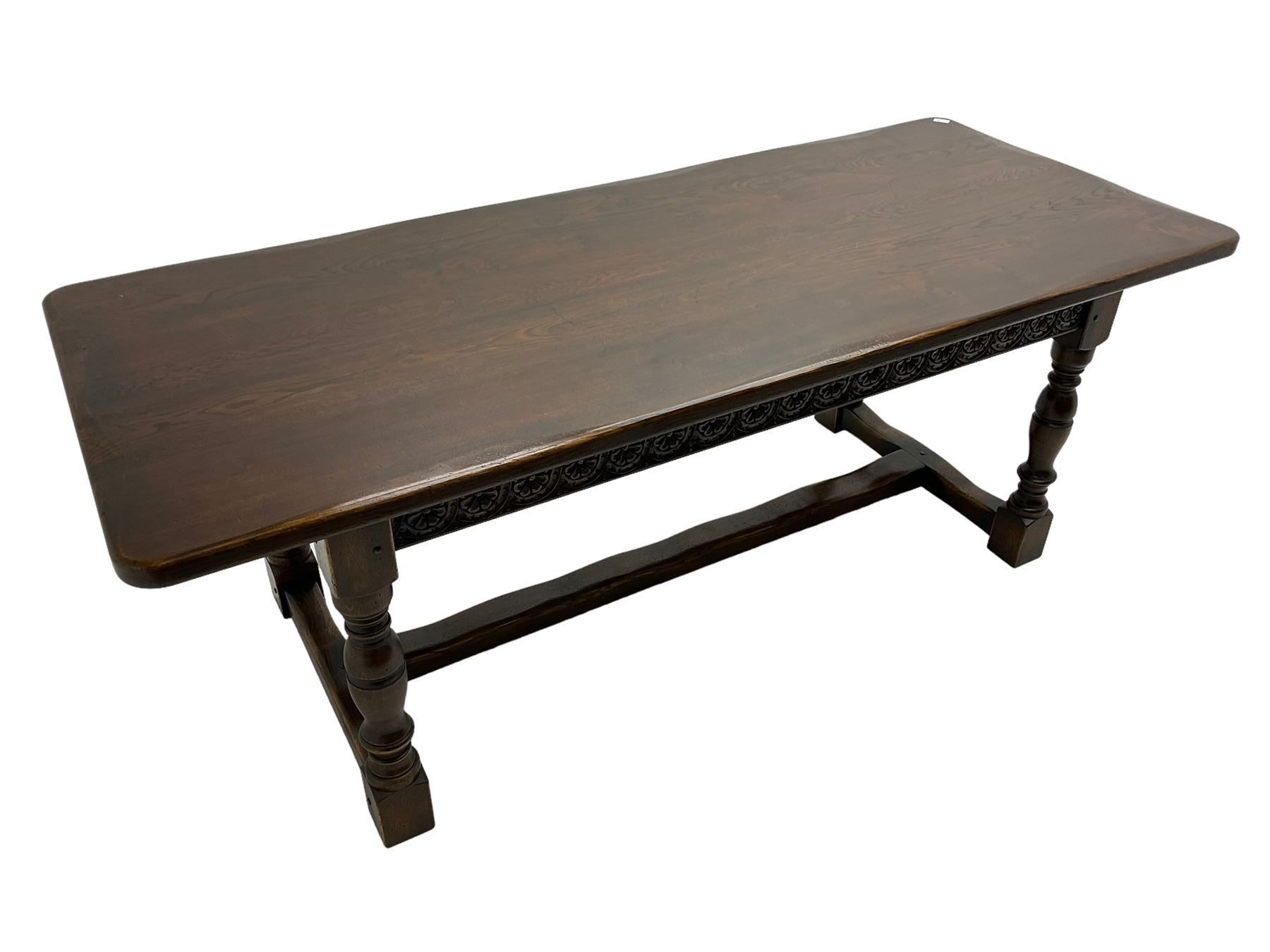 Large oak refectory dining table, rectangular top over guilloche carved frieze rails, turned supports joined stretchers