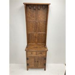 'Acornman' figured oak hallstand, raised panelled back fitted with four coat hooks, rectangular top over two drawers and double panelled cupboard, panelled sides, all over adzing, by Alan Grainger of Brandsby, York