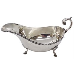 1930's silver sauce boat, with acanthus capped flying scroll handle and oblique gadrooned rim, upon three hoof feet, hallmarked S Blanckensee & Son Ltd, Chester 1933, including handle H9.5cm, L18cm, approximate weight 5.41 ozt (168.5 grams)