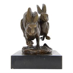 Bronze figure group, modelled as two hares in chase, signed Nick, with foundry mark, upon a rectangular base, H11cm L15cm