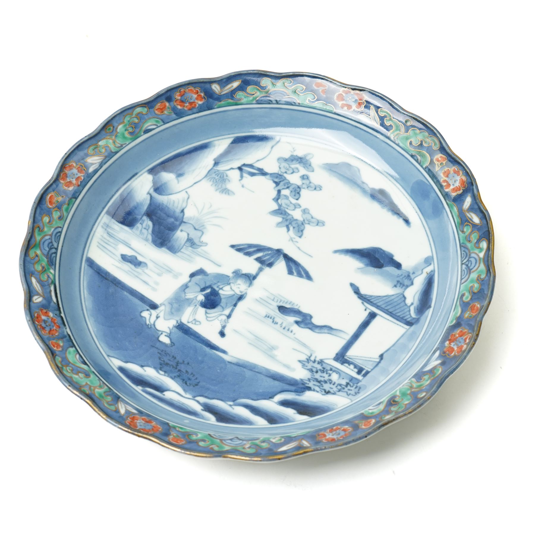 Japanese 19th century Arita style dish, painted centrally in blue and white with a lady carrying peaches, marked in blue to base, W28.5cm 