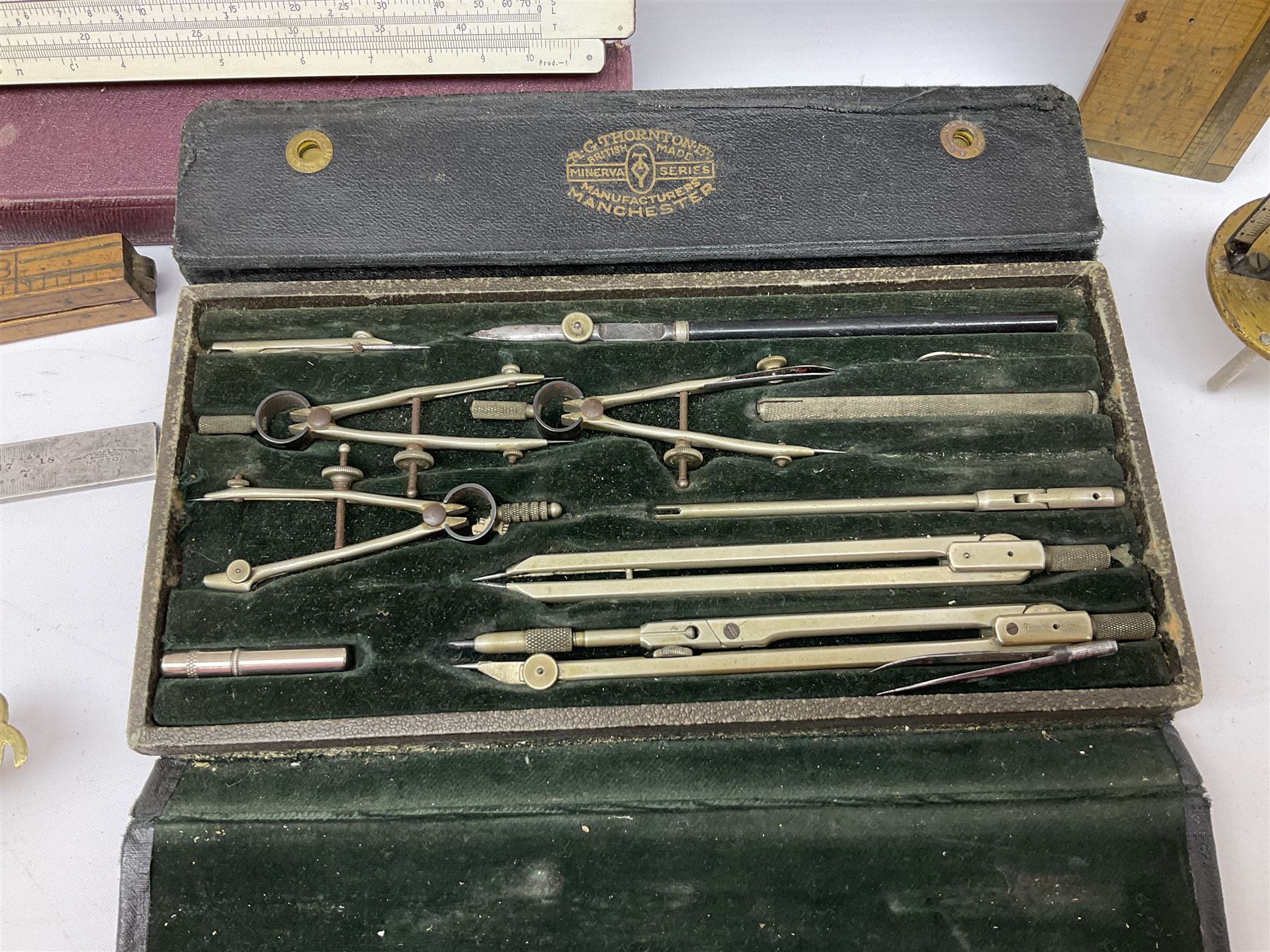 Two Victorian brass sovereign scales, one marked 'Harrison' L10cm; cased set of drawing instruments by G. Thornton Limited Manchester; Chesterman No.770/1 steel vernier caliper; two boxwood rulers; cased slide rule; brass and boxwood rope/wire gauge etc
