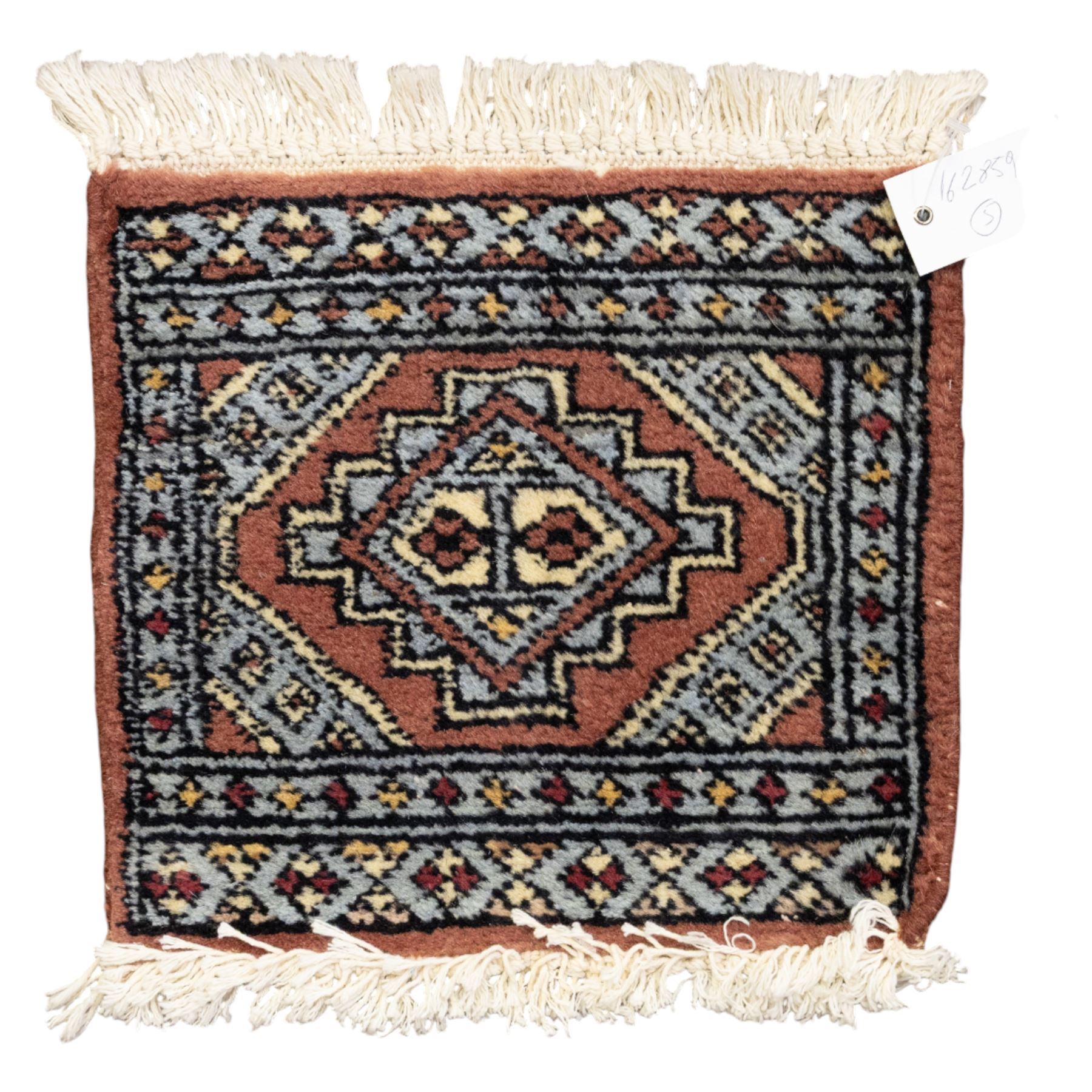 Long flatweave Kilim textile cushion, in crimson and decorated with geometric motifs and cotton fringe ends, 151cm, together with four modern hand-knotted rug mats with geometric designs, the largest 65x43cm, (5)