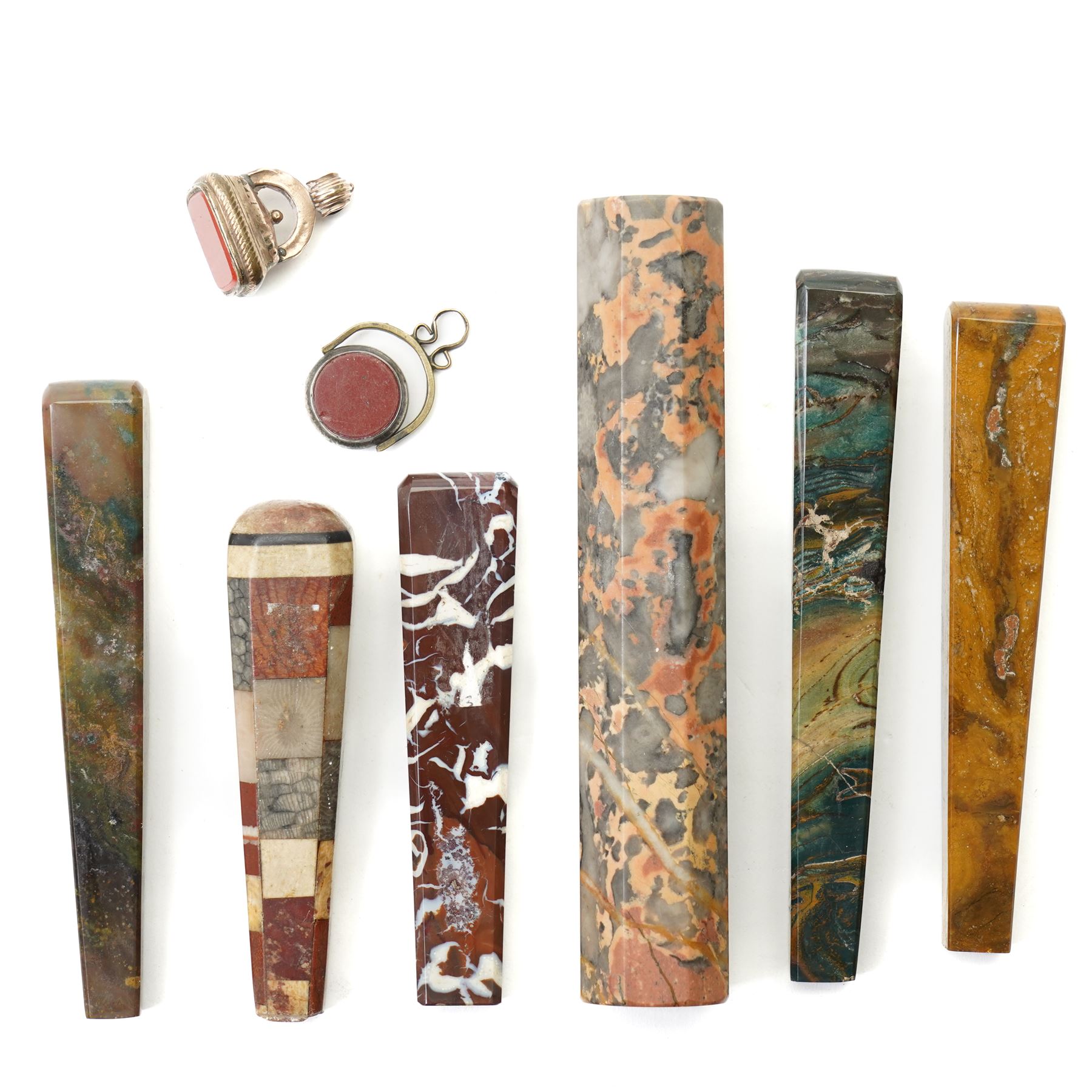 Collection of ten 19th century agate knife handles of varying designs, paperweight of octagonal design, swivel fob seal and a pinchbeck seal