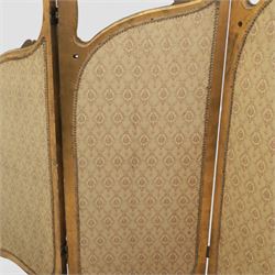 Rococo style giltwood three-panel dressing screen, each panel with shaped and scroll carved frame decorated with shell and foliate motifs, the upper sections glazed, the lower sections upholstered in patterned fabric, hinged to form a folding screen