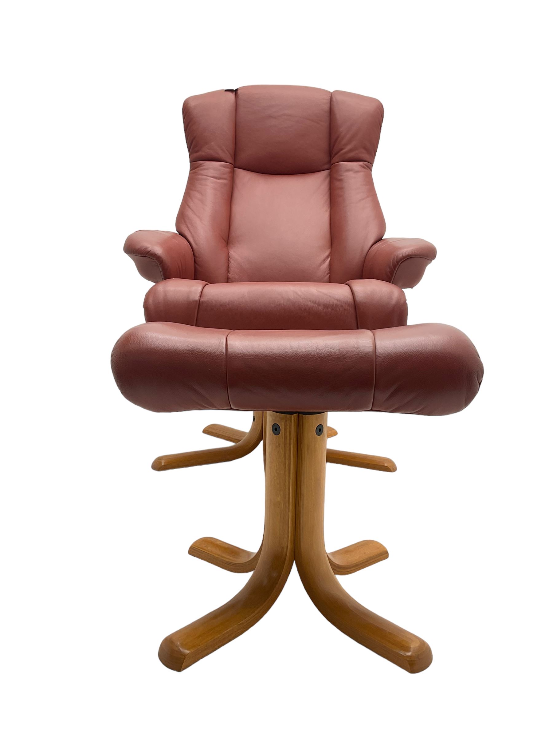 Mid-20th century design reclining armchair with swivel action, upholstered in red leather, raised on U-shaped supports with quadruform base, with matching footstool