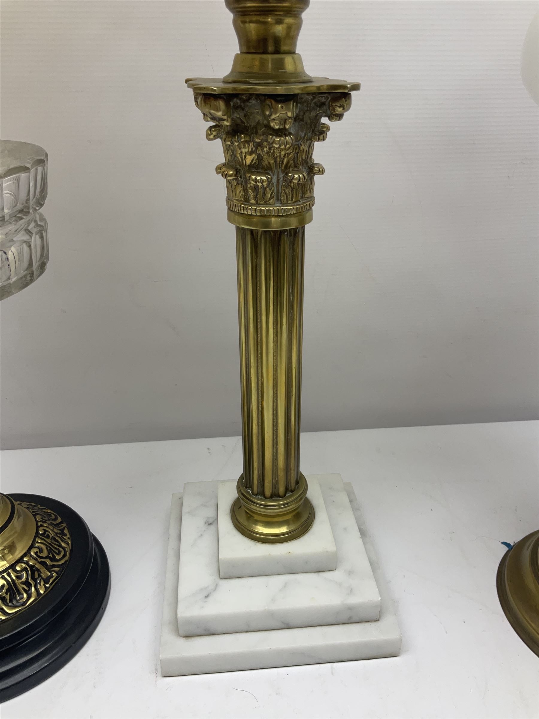 Brass Corinthian column oil lamp, upon stepped marble base, together three other brass table lamps, tallest H68cm