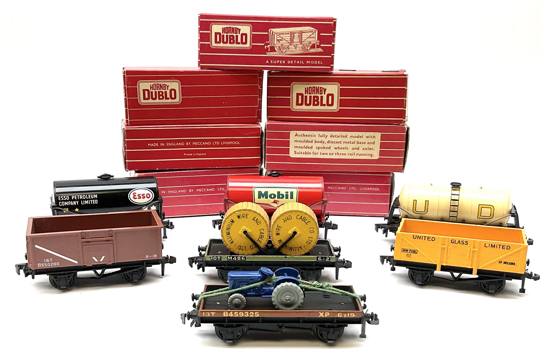 Hornby Dublo - 4646 Low-Sided Wagon D1 with cable drums; 4649 Low-Sided Wagon with tractor; 4656 16-Ton Mineral Wagon brown; 4657 United Dairies Milk Tank Wagon; 4660 U.G.B. Sand Wagon; 4677 Tank Wagon 'Mobil' (D1); and 4680 Tank Wagon 'Esso' (Fuel Oil); all boxed (7)