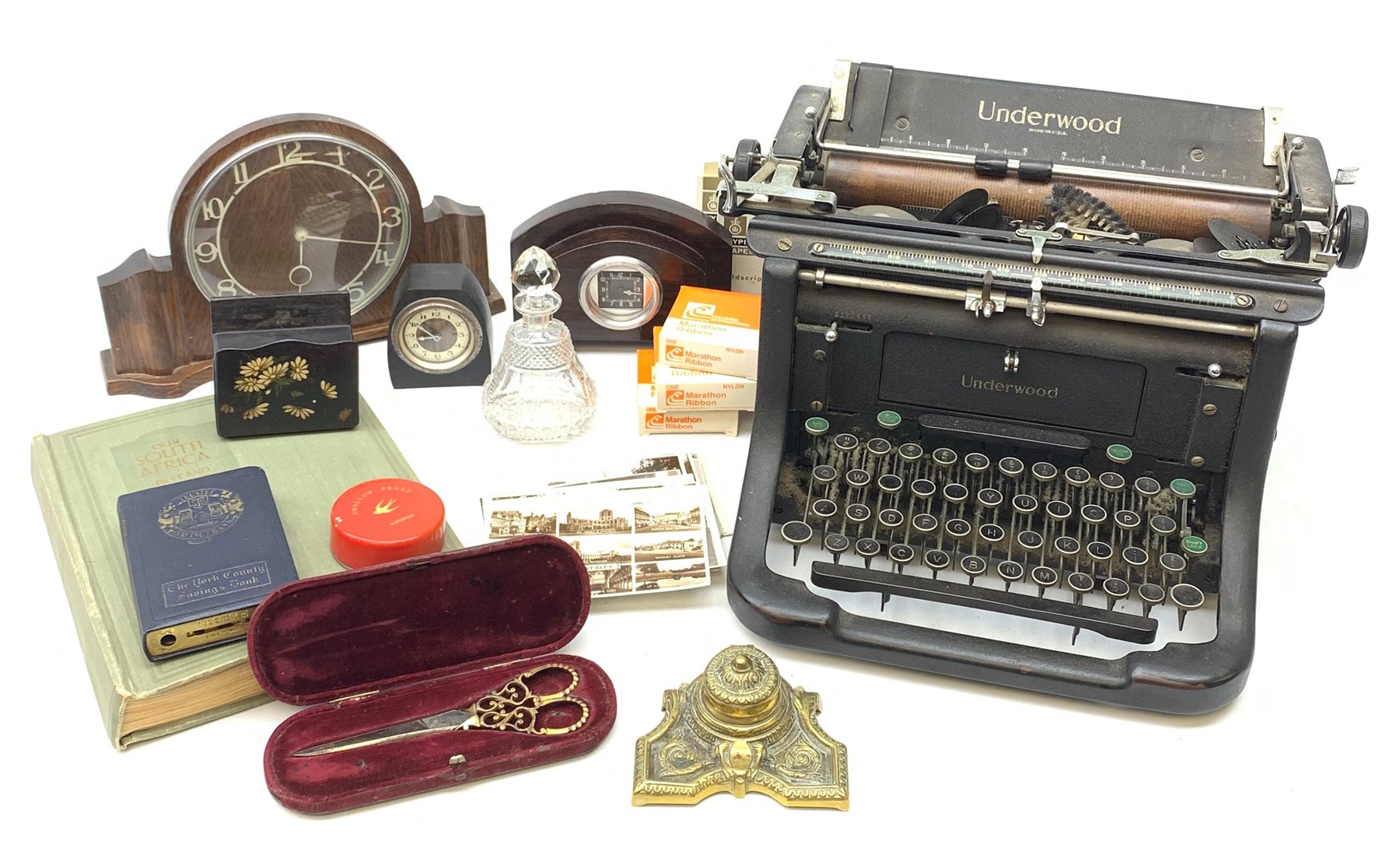 Three Art Deco mantle clocks, early 20th century cut glass scent bottle, Victorian papier mache box, vintage Underwood typewriter, brass inkwell, selection of early 20th century East Riding postcards, pair of Brookes and Crookes scissors with ornate pierced handles, cased etc 