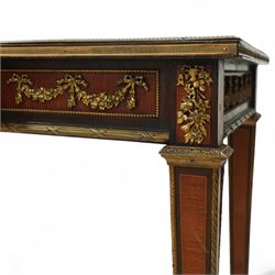 Fine 19th-century Louis XVI-style mahogany and gilt bronze-mounted writing table, rectangular top with a gilt tooled tan leather writing surface within a moulded gilt bronze edge above a frieze fitted with three drawers, mounted with floral and foliate gilt bronze swags  and borders, raised on square tapering legs with acanthus mounts and toupie feet