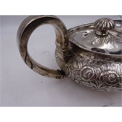 George III Irish silver teapot, of squat circular form, the body with repousse and chased floral and C scroll decoration, with capped C handle and ivory insulators, engraved to base 'Presented to Troop Sergeant Major John Percival, of the 4th Dragoon Guards by Alex D. Tait, Esq, late Captain in that corps as a mark of approbation of his steady and upright conduct when Sergeant Major of his Troop, Dublin, June 2nd 1843', hallmarked William Law, Dublin 1817, H12.5cm, This item has been registered for sale under Section 10 of the APHA Ivory Act