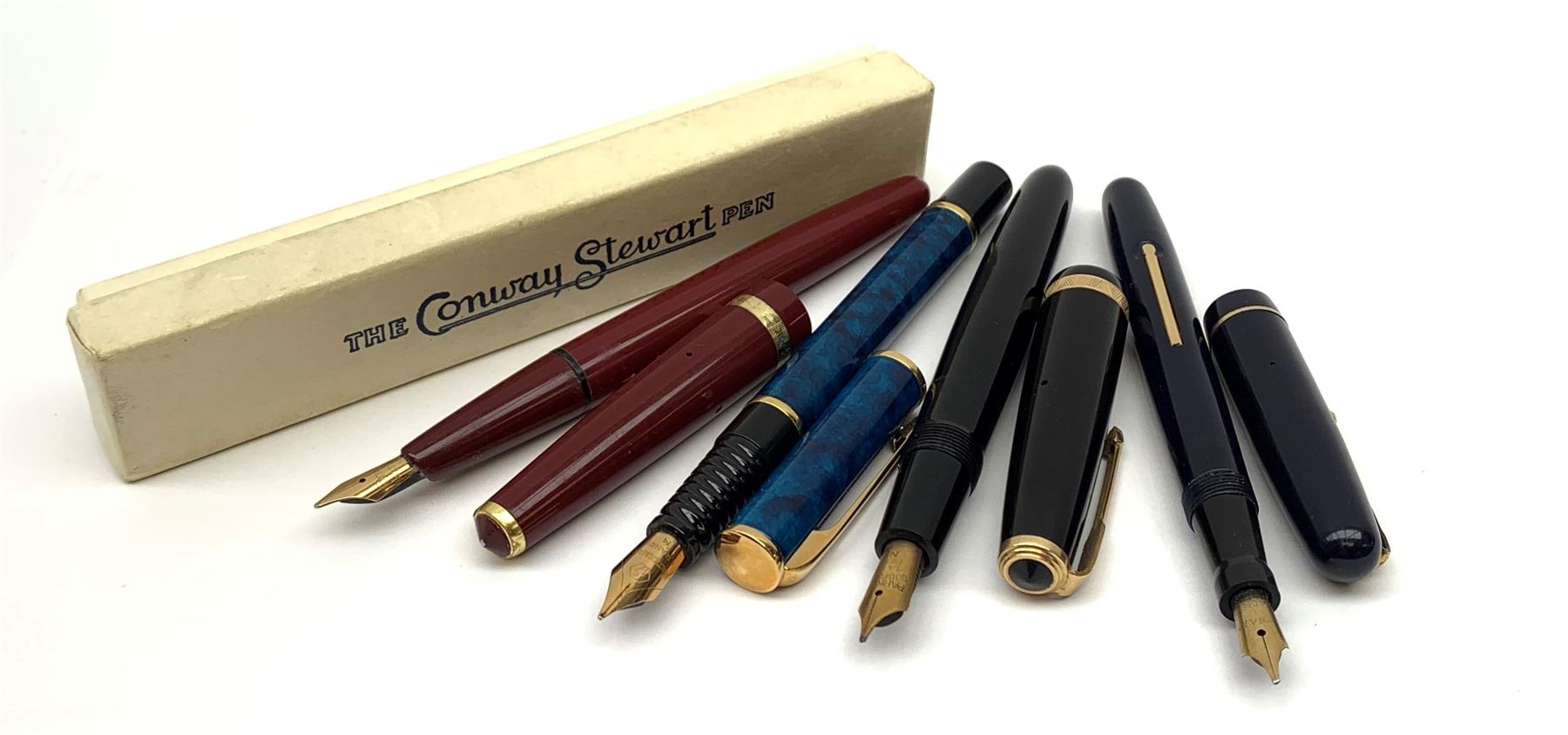 A group of four fountain pens, comprising Parker Duofold, nib marked 14K, Swan Mabbie Todd & Co Ltd Self Filler, nib marked 14C 585, Conway 57, nib marked 14ct, and Waterman Laureat. 
