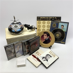 Elvis Presley - Bradford Exchange limited edition telephone, boxed with paperwork; framed 'Are You Lonesome Tonight' 45rpm record; six DVDs; RCA Victor boxed set of four LP records; collector's plate on stand; and unused notepad