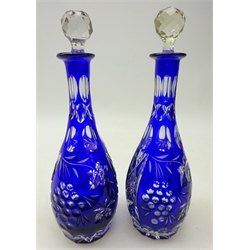  Pair early 20th century Bohemian cut glass and blue overlay decanters, with grape vine decoration and faceted clear glass stoppers, H30cm   