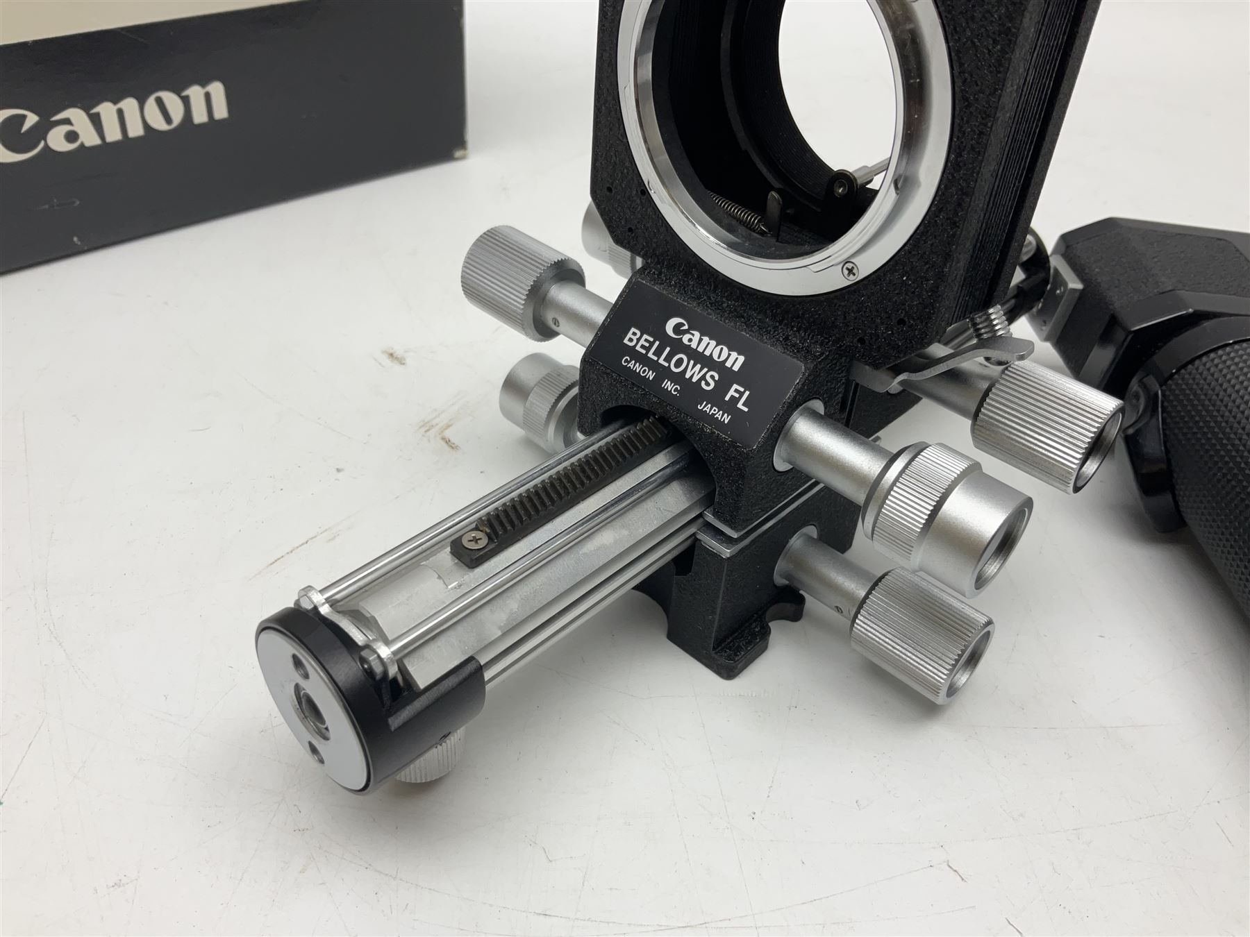 Collection of Canon lenses, to include 'Canon Lens FD 100mm 1:2.8', serial no 12821, 'Canon Lens FD 200mm 1:4' serial no 245313, 'Macro Canon Lens FL 50mm 1:3.5', serial no. 25505, 'Canon Lens FD 135mm 1:3.5 etc, together with other Canon equipment, including Bellows FL, Slide Duplicator etc 