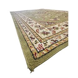 Turkish Sincerity Royale green ground rug, the field decorated with a central floral medallion surrounded by scrolling floral motifs in shades of cream, beige, and burgundy, spandrels filled with matching floral designs, the border featuring a series of floral patterns on a cream ground, finished with green edges
