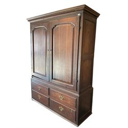 George III oak press cupboard, dentil cornice over two arch fielded panel doors, the base fitted with four drawers with pressed brass handle plates