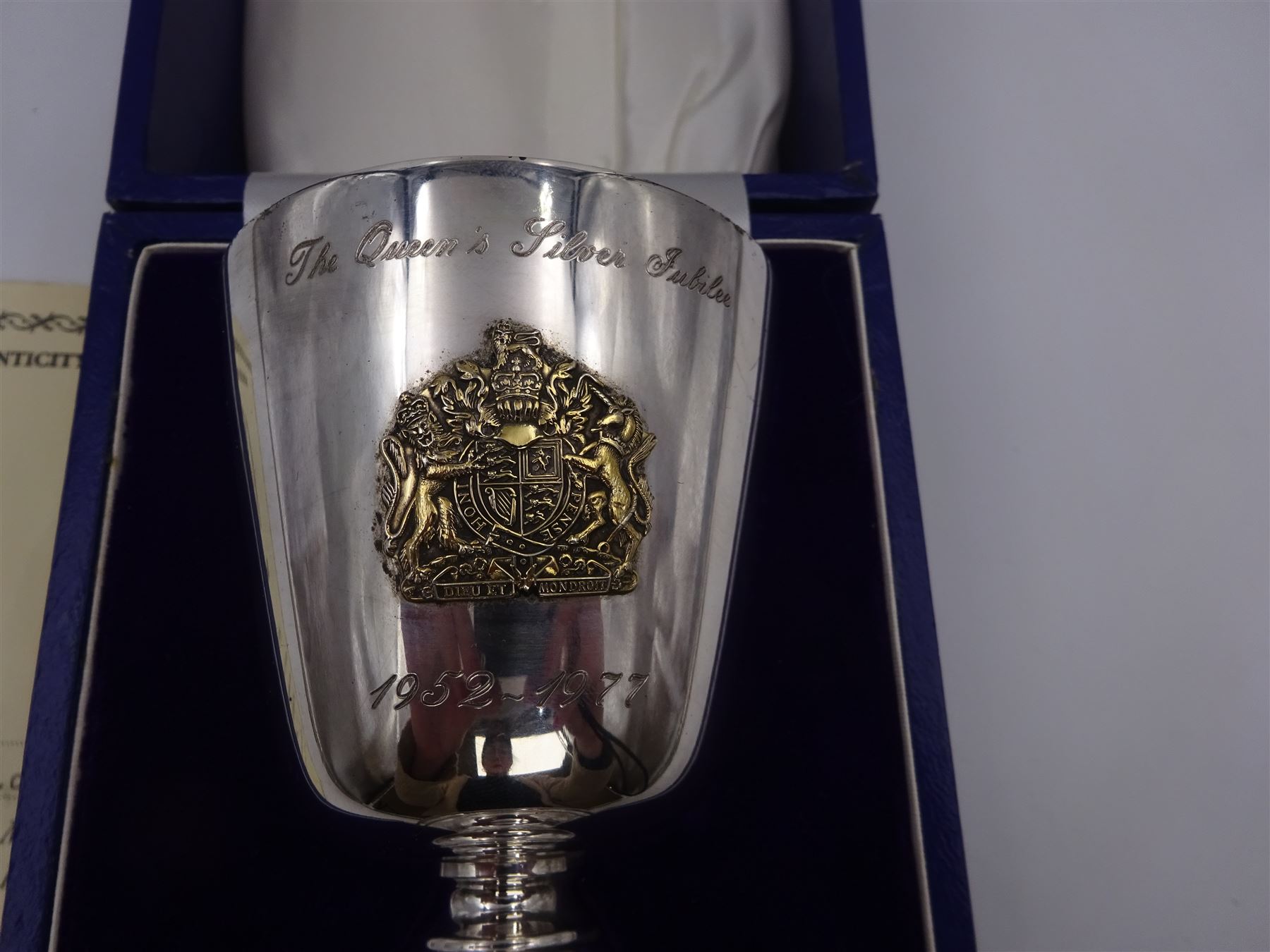 Modern limited edition silver goblet, commemorating Queen Elizabeth II silver jubilee, of plain form with gilded interior, applied Royal coat of arms to body and engraved 'The Queen's Silver Jubilee 1952-1977' upon knopped stem and circular spreading foot, limited edition no. 320/1000, hallmarked A T Cannon Ltd, Sheffield 1977, boxed with certificate, goblet H12.8cm