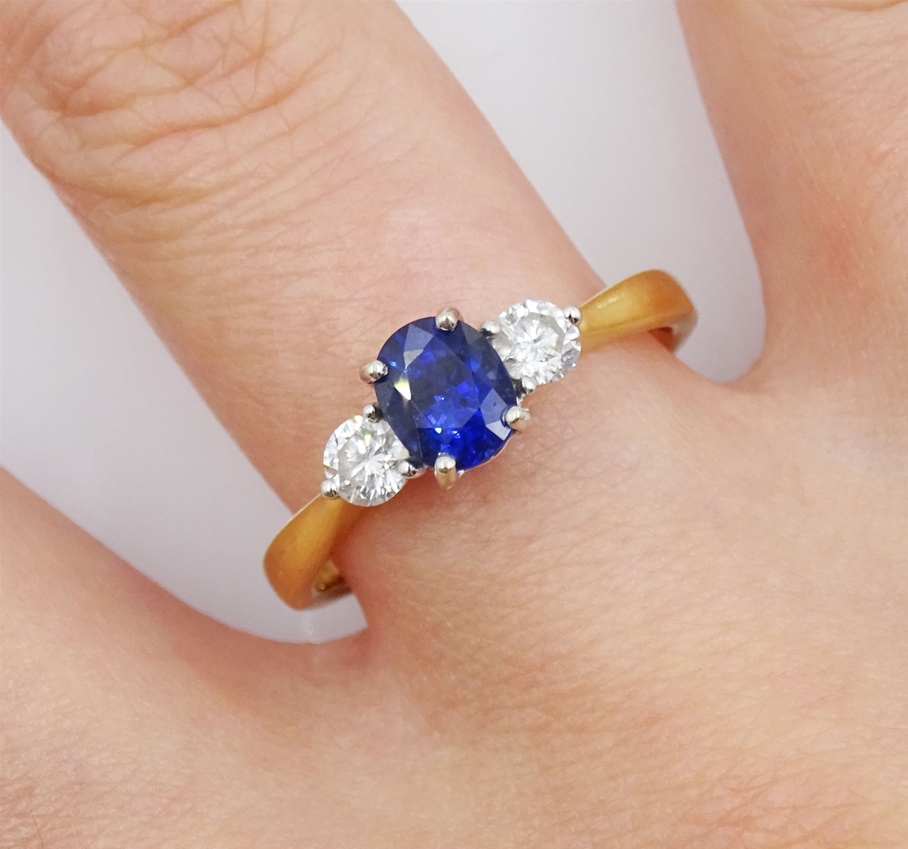 18ct gold three stone oval sapphire and round brilliant cut diamond ring, stamped 18KT, total diamond weight approx 0.30 carat, sapphire approx 0.80 carat