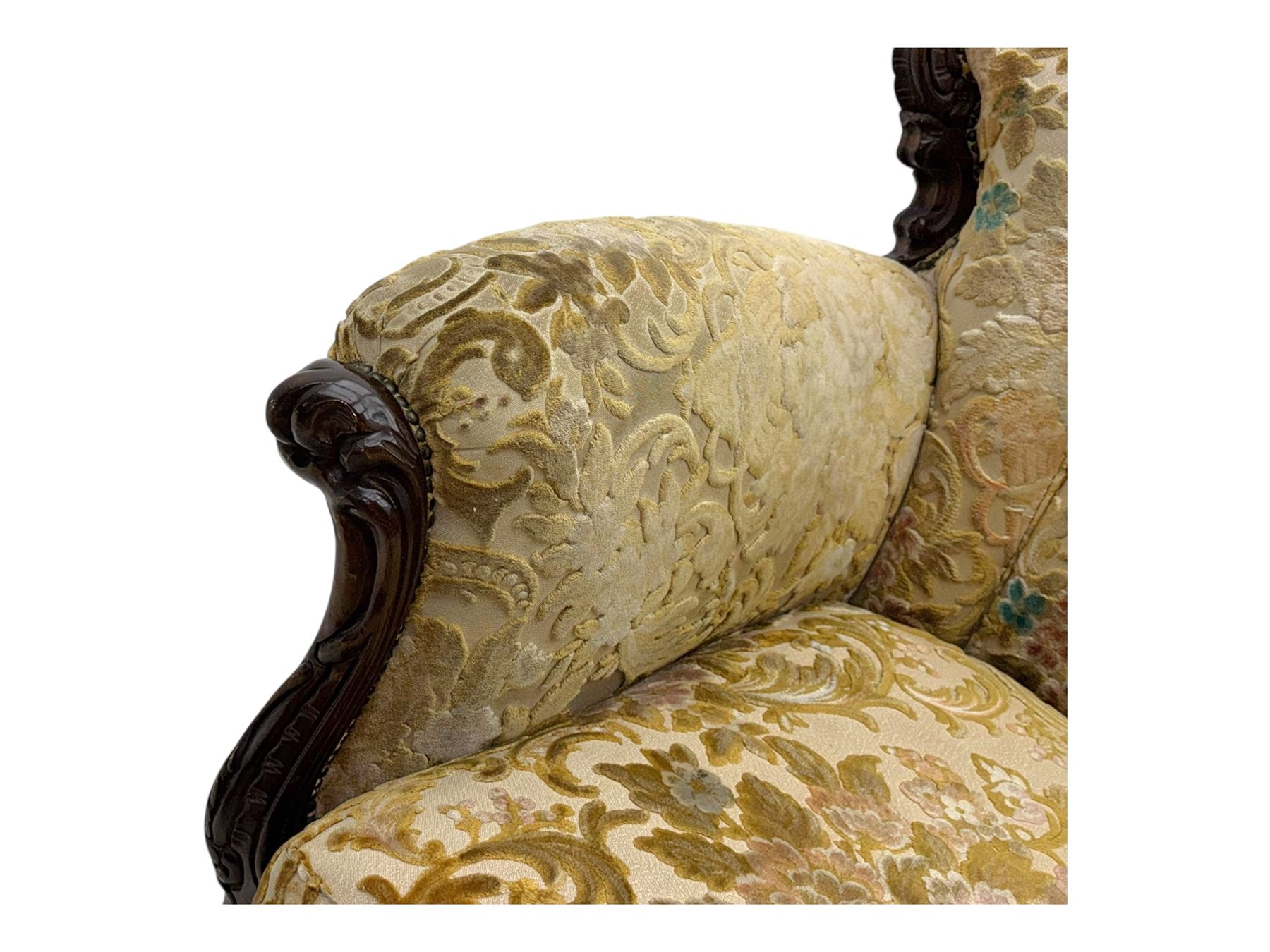 Victorian design stained wood three seater settee, top rail carved and scrolled, padded back and arms, scrolled cabriole feet 