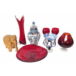  Makkum urn, collection of red art glass including large bowl and a carved wooden elephant, etc