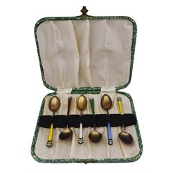 Set of six early 20th century Norwegian silver gilt and enamel coffee spoons, the stems with guilloche enamel in red, green, white, yellow and blue, marked 925 and bearing marks for David Andersen, Oslo, also hallmarked Chester import 1924, makers mark W.C.G, possibly Wilfred Chidlaw Griffiths, L9.5cm, in fitted case, approximate gross silver weight 1.52 ozt (47.4 grams)
