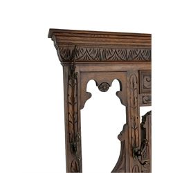 Victorian heavily carved oak hall-stand, moulded cornice with foliate carved decoration over bevelled mirror back, drop centre with hinged box seat flanked by stick or umbrella stands, scrolls and foliate carved decoration