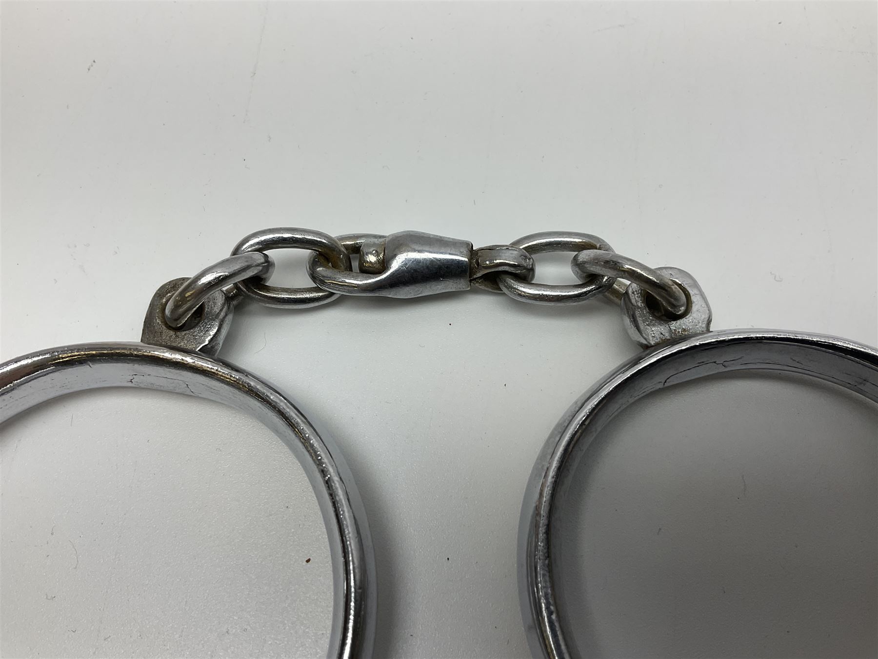 Police - two pairs of steel nipper handcuffs, one stamped Hull City Police; two other chromium plated Hiatt steel nipper handcuffs, each stamped HCP (?Hull City Police); and a pair of chromed steel articulated handcuffs stamped WRC (?West Riding Constabulary) (5)